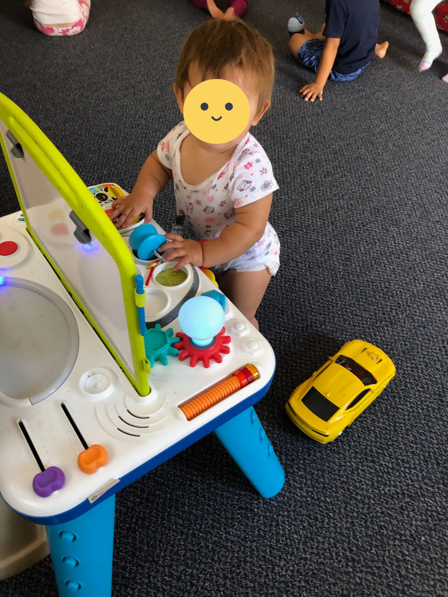 A baby playing with an interactive toy.